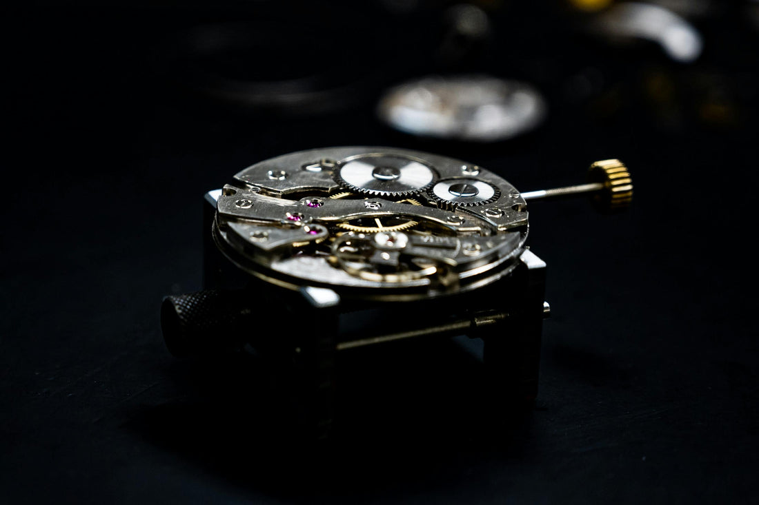 Close-up of an automatic watch movement showing rotor and gears