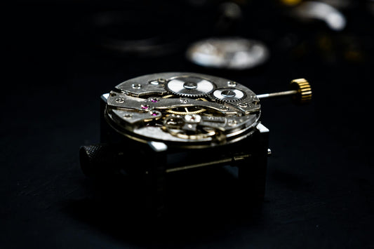 Close-up of an automatic watch movement showing rotor and gears